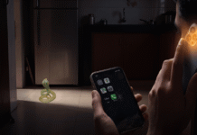 Why Snake Rescue Needs a Helpline, Not a Consumer App A cobra in a dark kitchen at night, with one hand fumbling at a cracked phone screen while another holds a phone to the ear